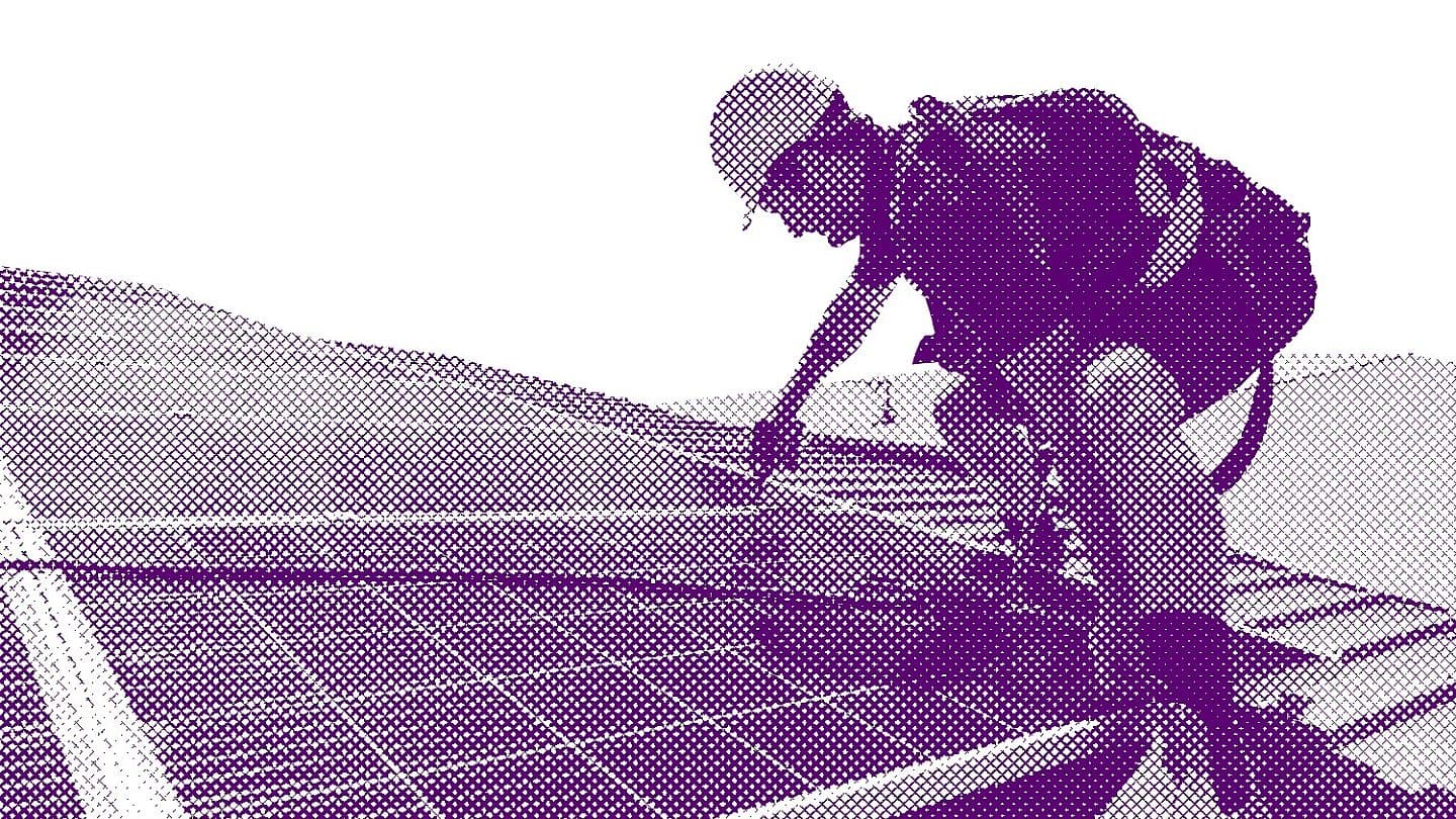Stock photo solar panel technician with drill installing solar panels on roof on a sunny day 1071423899
